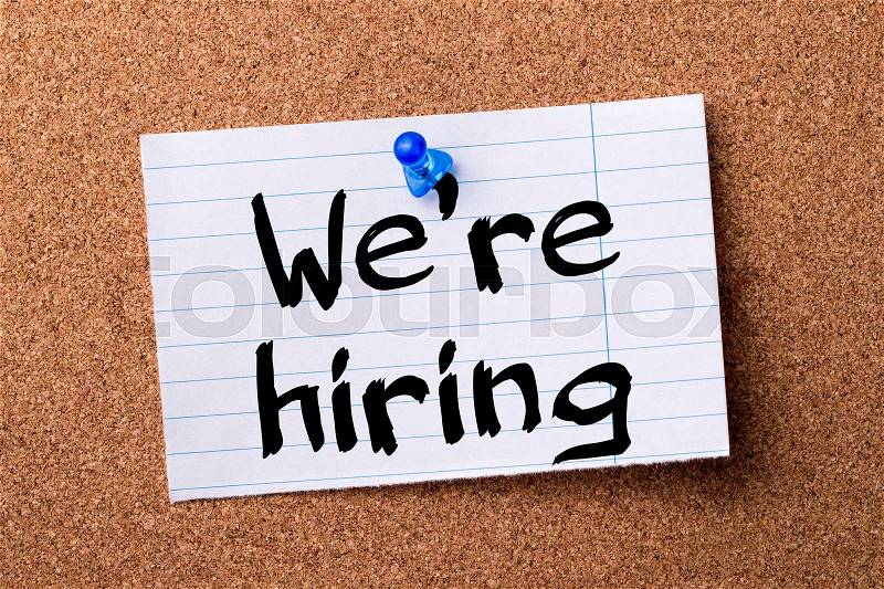 We’re hiring - teared note paper pinned on bulletin board - horizontal image, stock photo