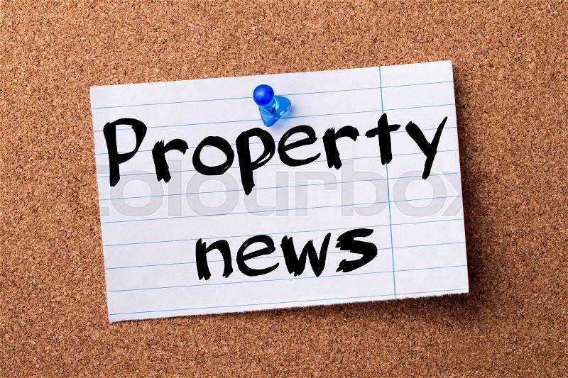 Property news - teared note paper pinned on bulletin board - horizontal image, stock photo