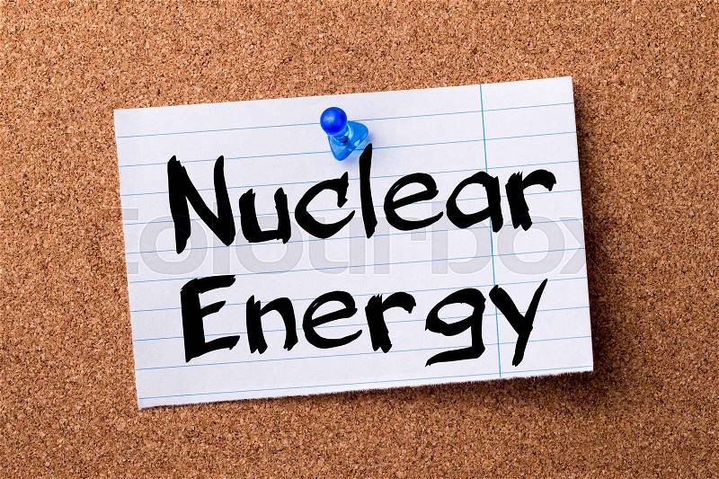 Nuclear Energy - teared note paper pinned on bulletin board - horizontal image, stock photo