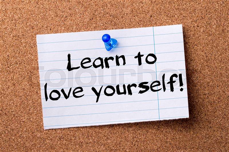 Learn to love yourself! - teared note paper pinned on bulletin board - horizontal image, stock photo