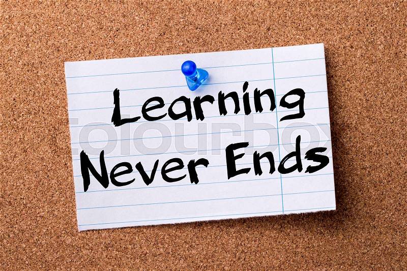 Learning Never Ends - teared note paper pinned on bulletin board - horizontal image, stock photo