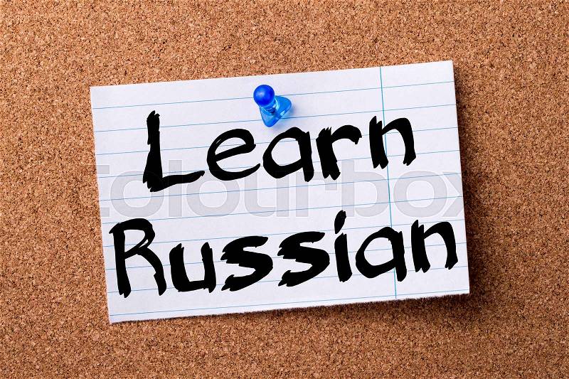 Learn Russian - teared note paper pinned on bulletin board - horizontal image, stock photo