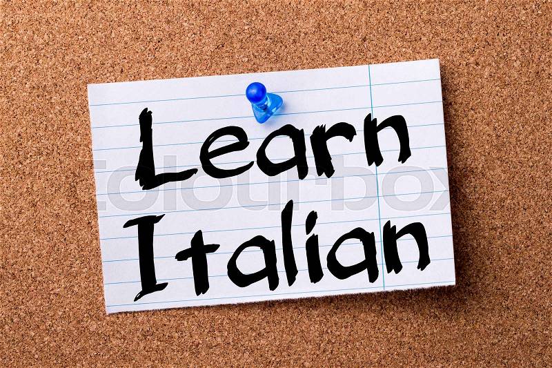 Learn Italian - teared note paper pinned on bulletin board - horizontal image, stock photo