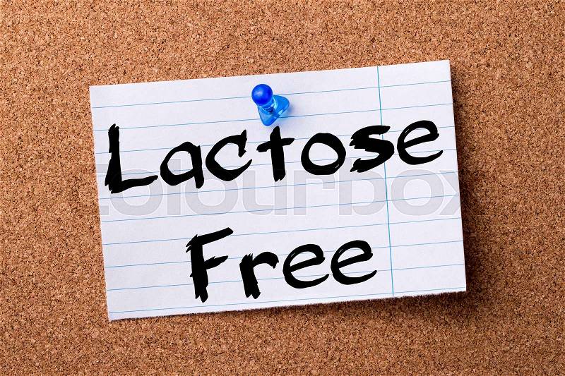 Lactose Free - teared note paper pinned on bulletin board - horizontal image, stock photo