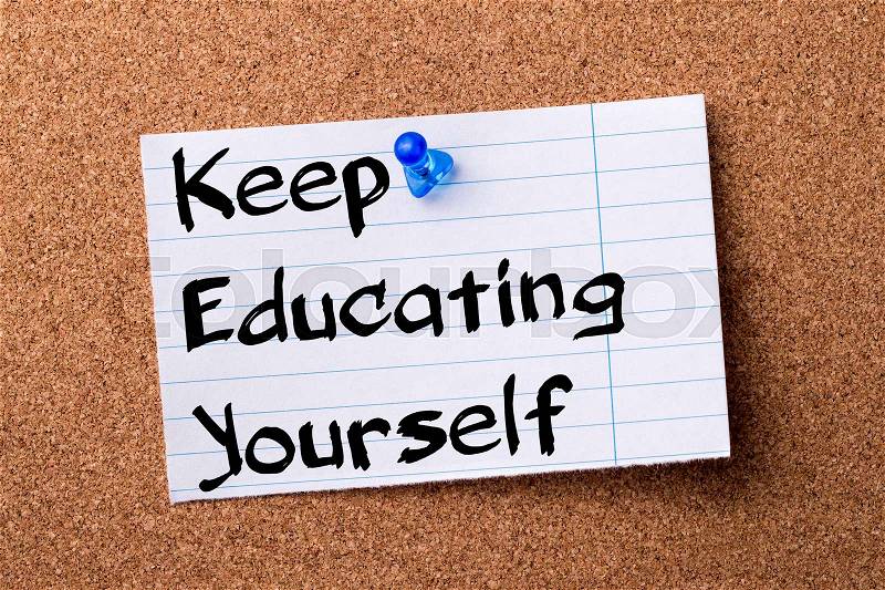 Keep Educating Yourself (KEY) - teared note paper pinned on bulletin board - horizontal image, stock photo