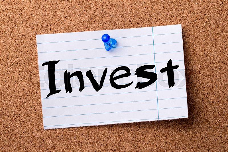 Invest - teared note paper pinned on bulletin board - horizontal image, stock photo