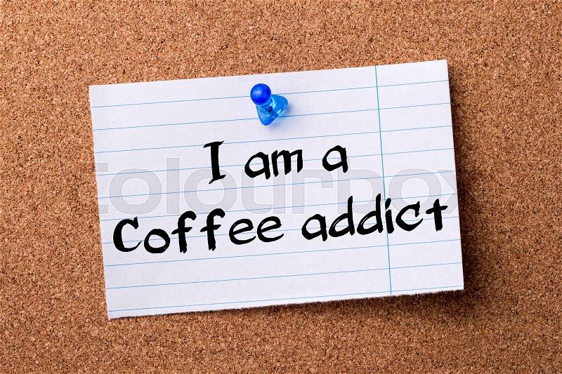 I am a Coffee addict - teared note paper pinned on bulletin board - horizontal image, stock photo