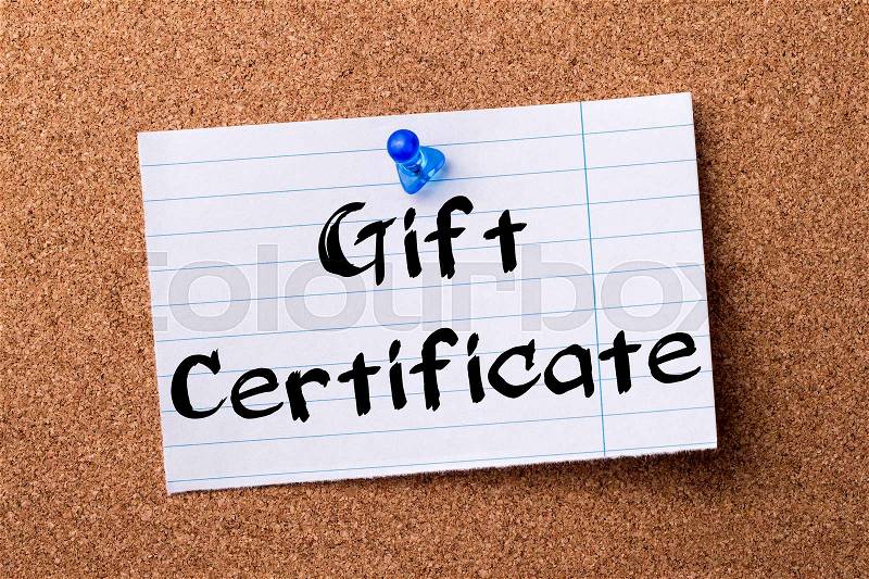 Gift Certificate - teared note paper pinned on bulletin board - horizontal image, stock photo