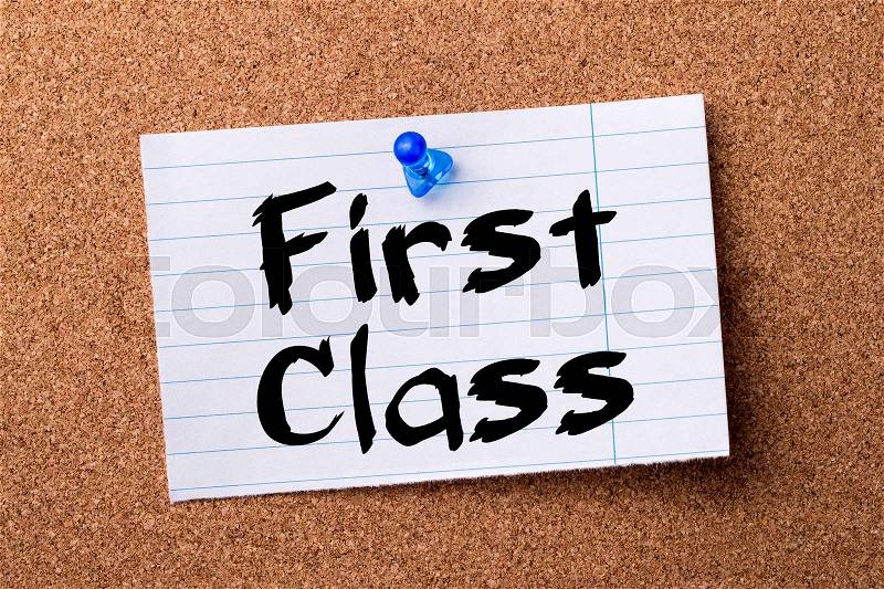 First Class - teared note paper pinned on bulletin board - horizontal image, stock photo