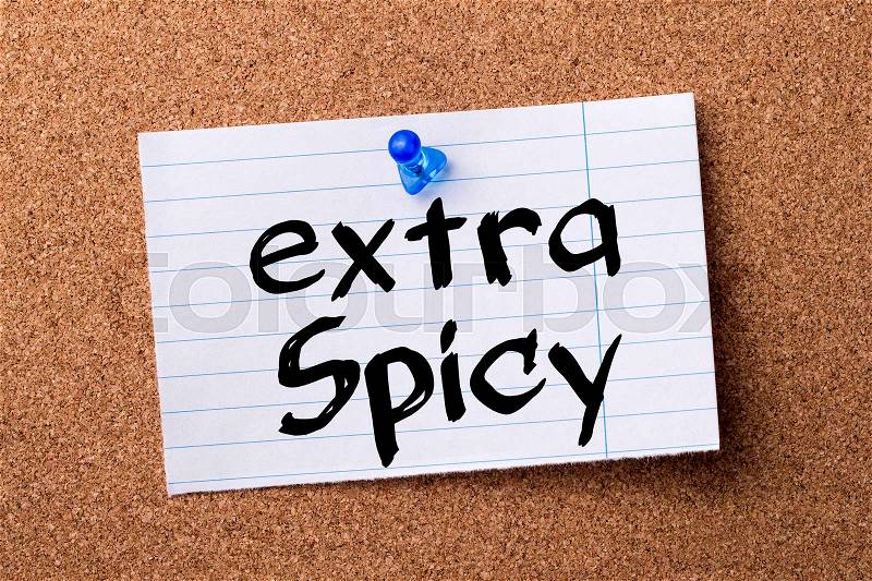 Extra spicy - teared note paper pinned on bulletin board - horizontal image, stock photo