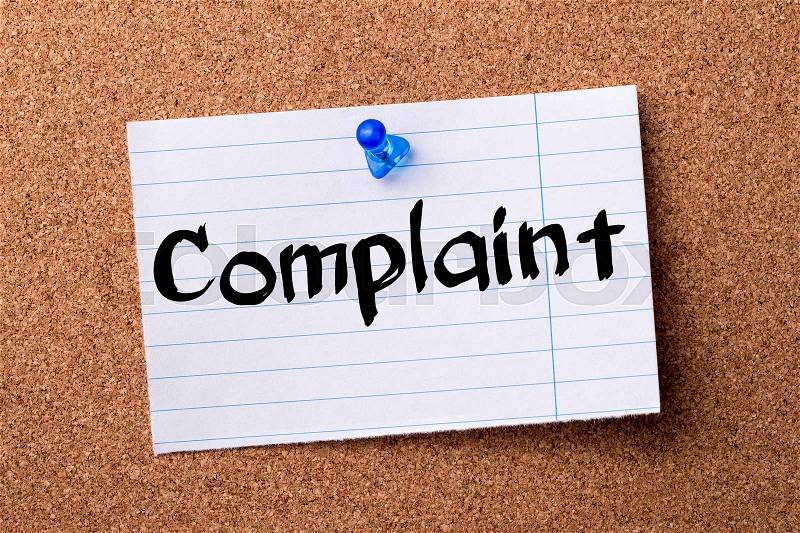 Complaint - teared note paper pinned on bulletin board - horizontal image, stock photo