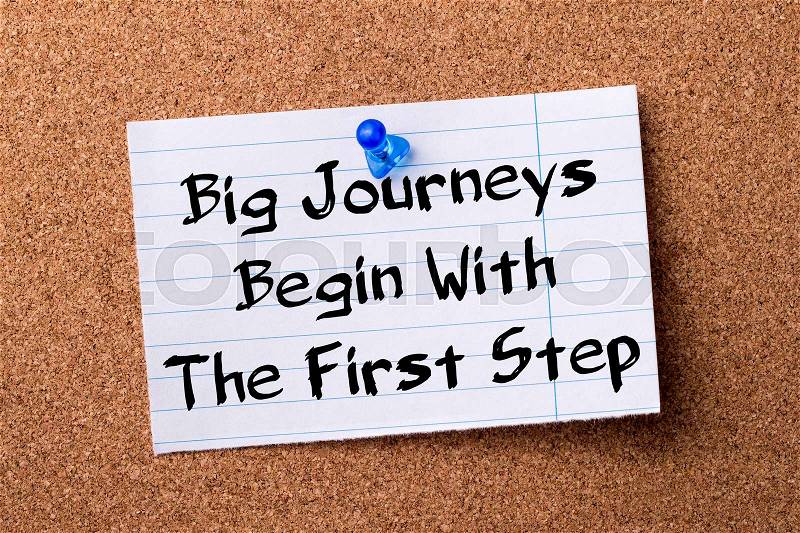 Big Journeys Begin With The First Step - teared note paper pinned on bulletin board - horizontal image, stock photo