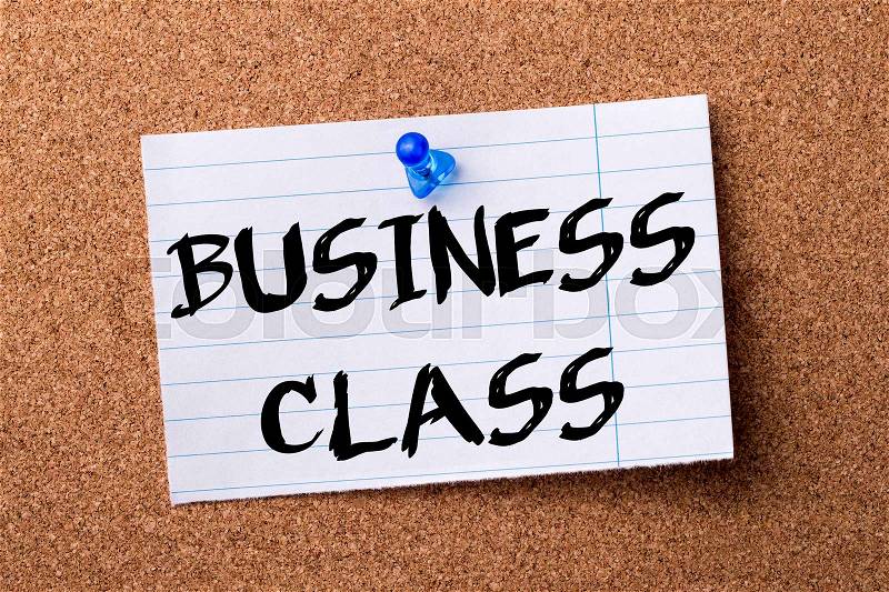BUSINESS CLASS - teared note paper pinned on bulletin board - horizontal image, stock photo