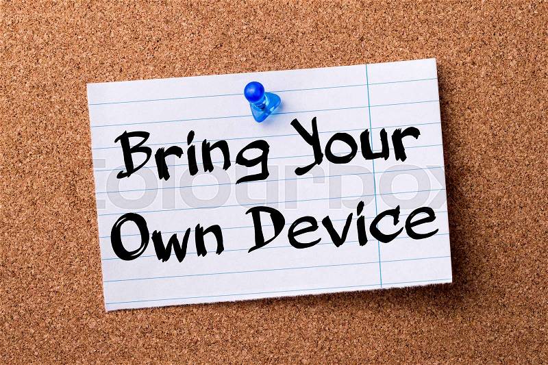 Bring Your Own Device BYOD - teared note paper pinned on bulletin board - horizontal image, stock photo