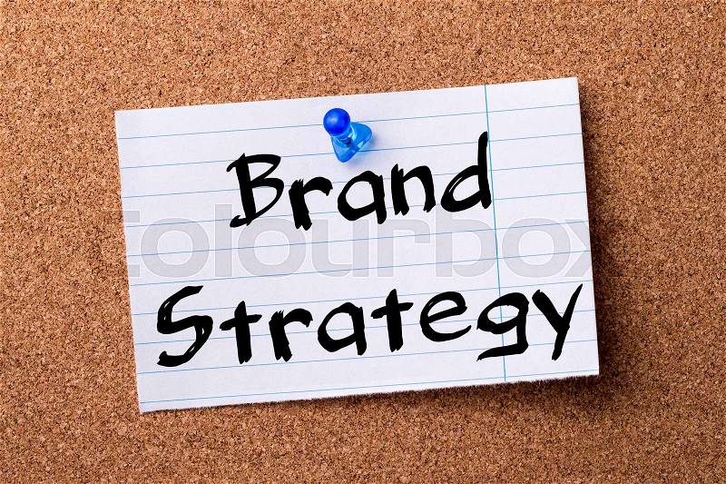 Brand Strategy - teared note paper pinned on bulletin board - horizontal image, stock photo