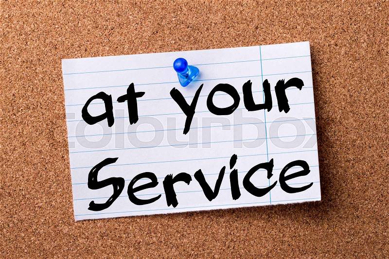 At your service - teared note paper pinned on bulletin board - horizontal image, stock photo