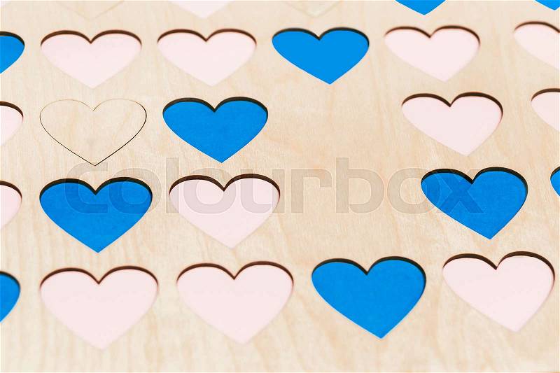 Carved small wooden hearts on table. Close-up, stock photo