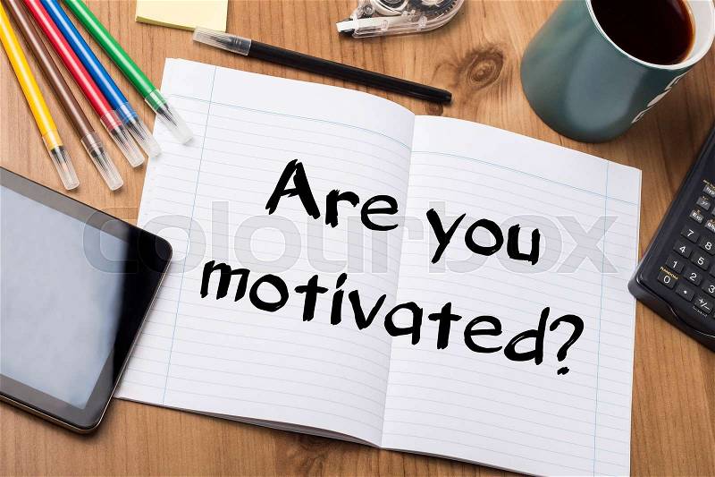 Are you motivated? - Note Pad With Text On Wooden Table - with office tools, stock photo