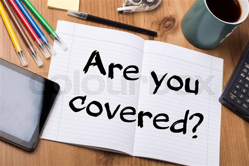 Are you covered? - Note Pad With Text On Wooden Table - with office tools, stock photo