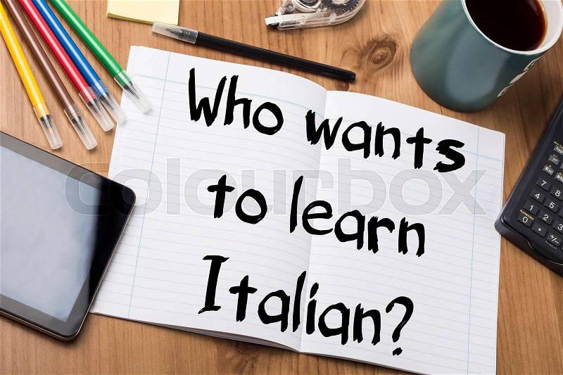 Who wants to learn Italian? - Note Pad With Text On Wooden Table - with office tools, stock photo