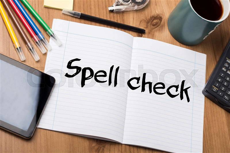 Spell check - Note Pad With Text On Wooden Table - with office tools, stock photo