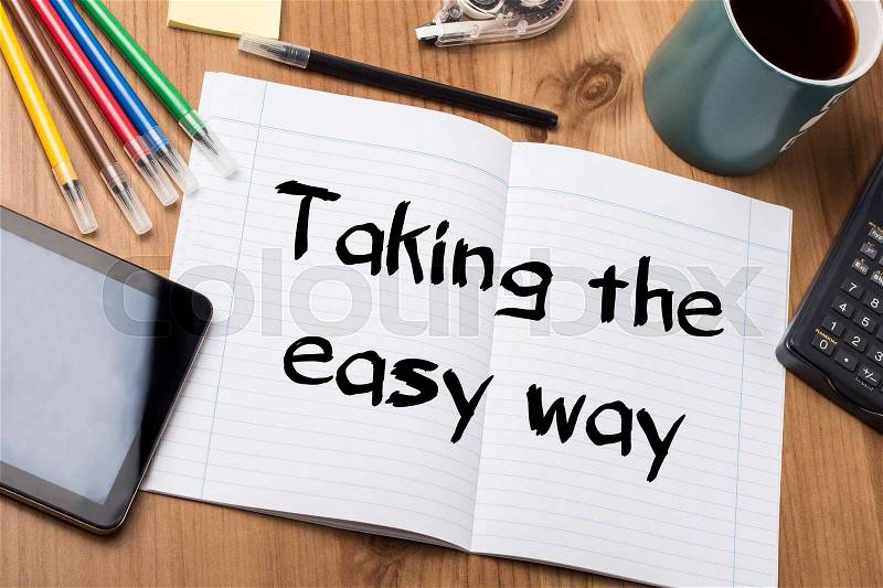 Taking the easy way - Note Pad With Text On Wooden Table - with office tools, stock photo