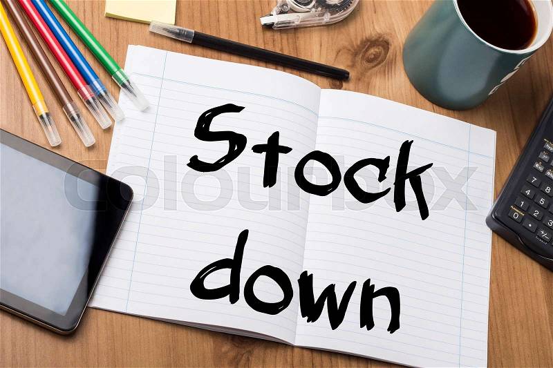 Stock down - Note Pad With Text On Wooden Table - with office tools, stock photo
