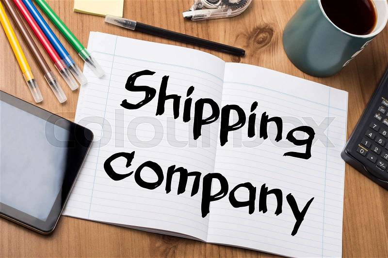 Shipping company - Note Pad With Text On Wooden Table - with office tools, stock photo