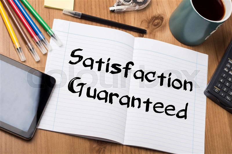 Satisfaction Guaranteed - Note Pad With Text On Wooden Table - with office tools, stock photo