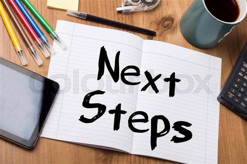 Next Steps - Note Pad With Text On Wooden Table - with office tools, stock photo