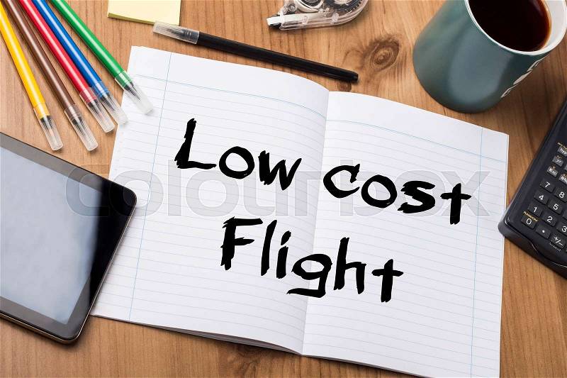 Low cost Flight - Note Pad With Text On Wooden Table - with office tools, stock photo
