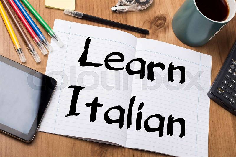 Learn Italian - Note Pad With Text On Wooden Table - with office tools, stock photo