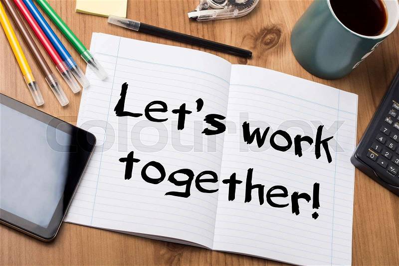 Let’s work together! - Note Pad With Text On Wooden Table - with office tools, stock photo