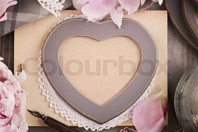 Wooden Heart Frame and Peony Flowers on Vintage Background. Retro Photo Album Cover. Top View, stock photo