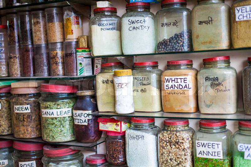 Jars of herbs and powders in a indian spice shop, stock photo