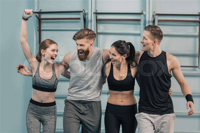 Smiling sporty men and women in gym , stock photo