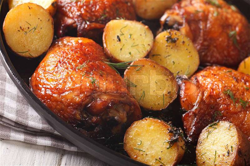 Delicious maple chicken thighs and baby potatoes close-up on a plate. horizontal , stock photo