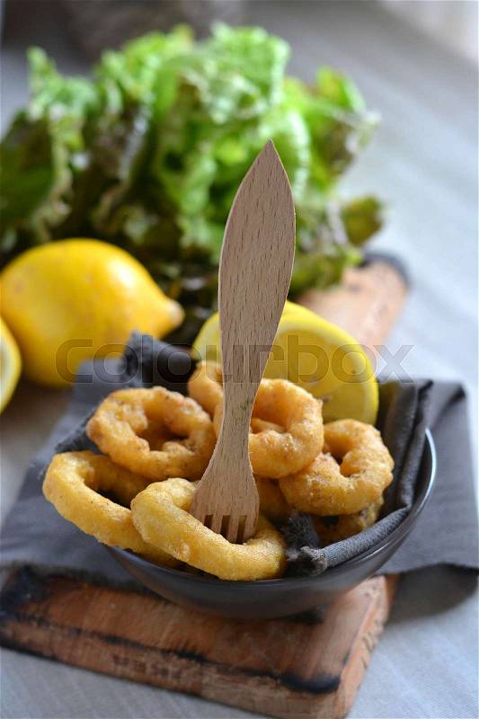 Spanish cuisine. Dish with Fried Calamari accompanied by lemon, stock photo