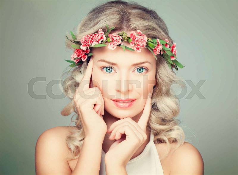 Beautiful Woman Touching Her Hand Her Face. Nice Model in Flowers Wreath, stock photo