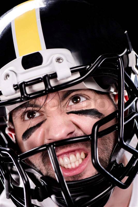 Close-up view of angry man american football player in helmet looking away, stock photo