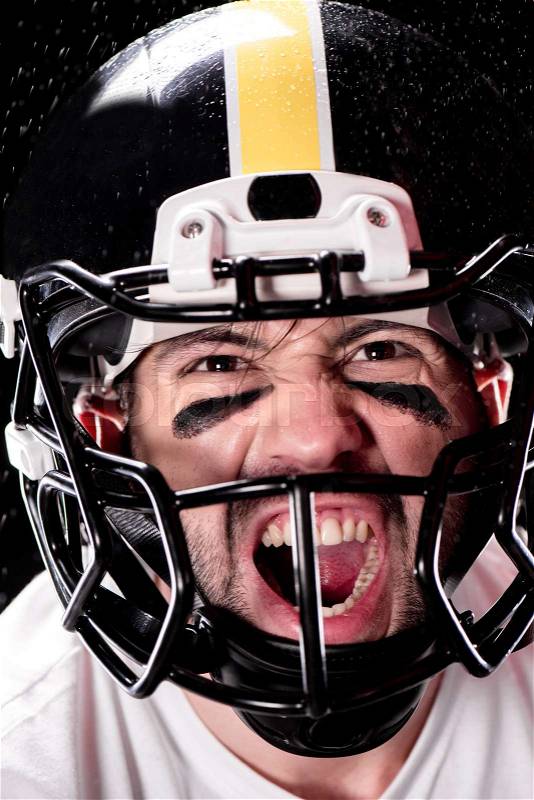 Close-up view of angry man american football player in helmet looking at camera, stock photo