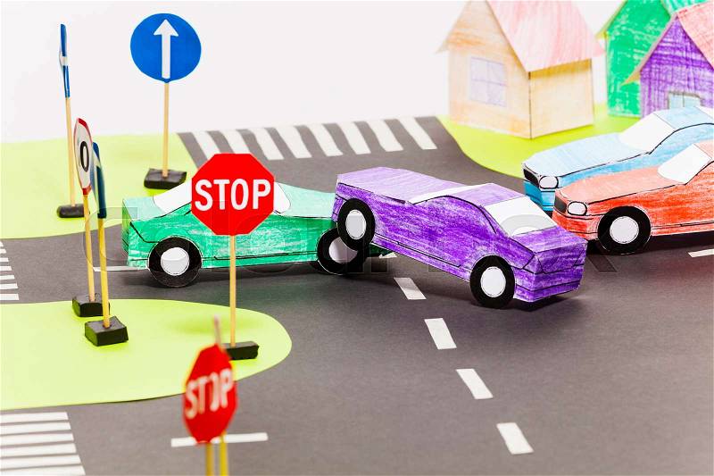 Road accident on a crossings with two handmade paper cars at the toy city, stock photo