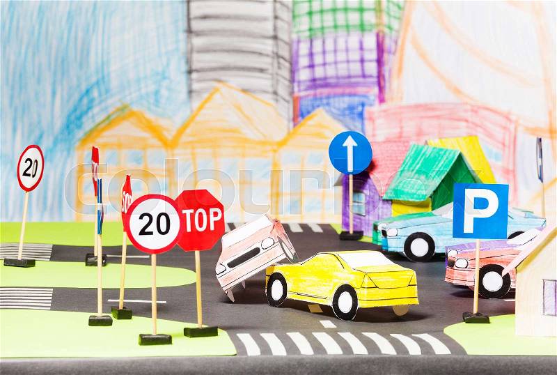 Road accident of two paper cars in the toy city maquette model, stock photo