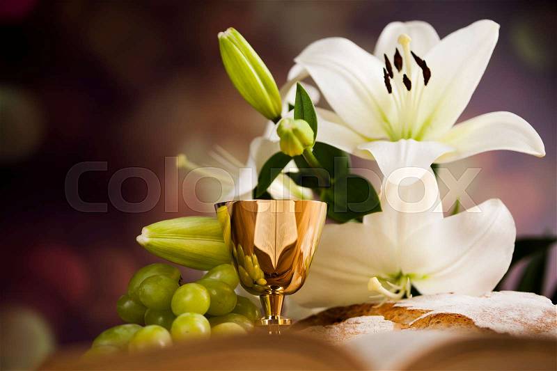 Symbol christianity religion a golden chalice with grapes and bread wafers and flower, stock photo