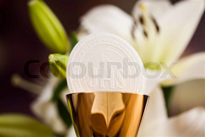 Symbol christianity religion a golden chalice with grapes and bread wafers and flower, stock photo