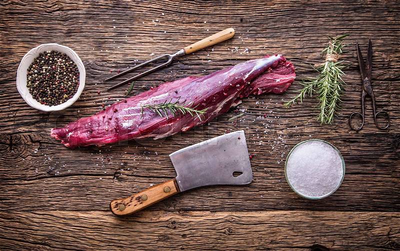 Raw beef meat. Raw beef tenderloin steak on a cutting board with rosemary pepper salt in other positions, stock photo