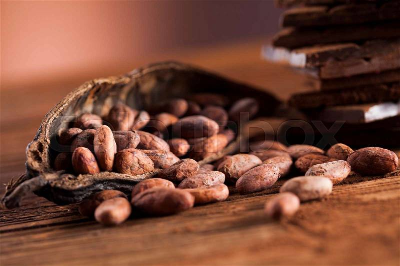 Cocoa pod and cocoa beans on the wooden table, stock photo