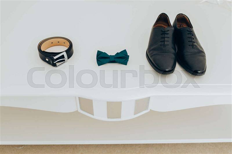 Trendy men\'s strap bow tie and shoes. Accesories, close-up. Set groom bow ties, shoes on white background, stock photo