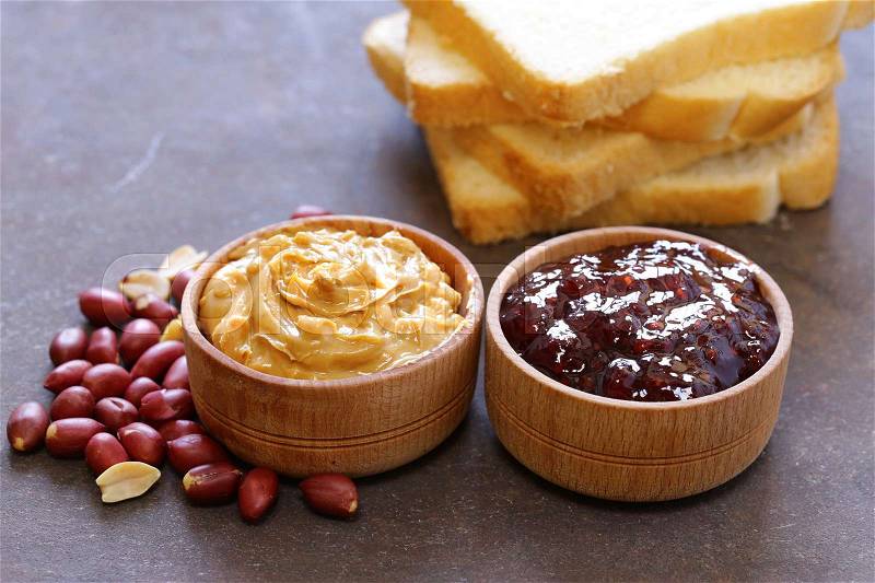 Natural peanut butter and berries jam for sandwiches, stock photo