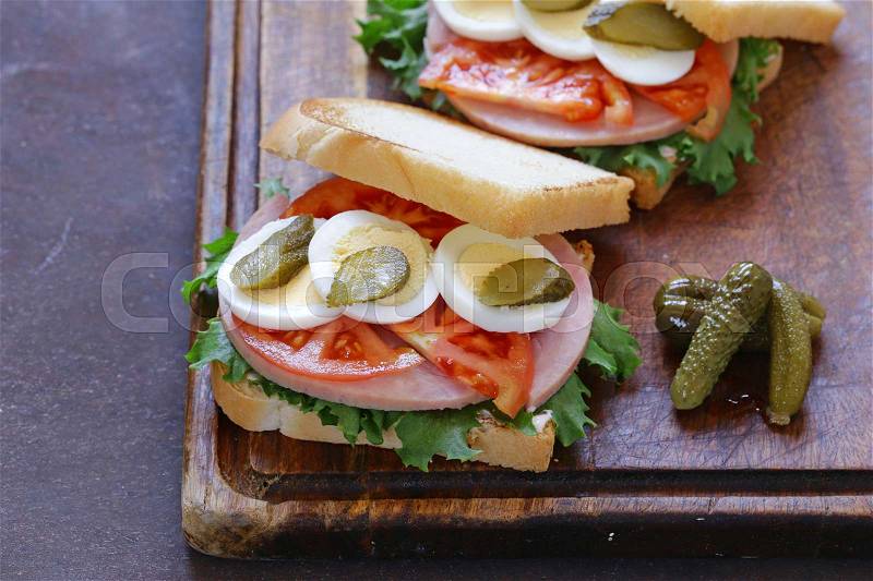 Sandwich with ham, tomato, egg and pickles, stock photo